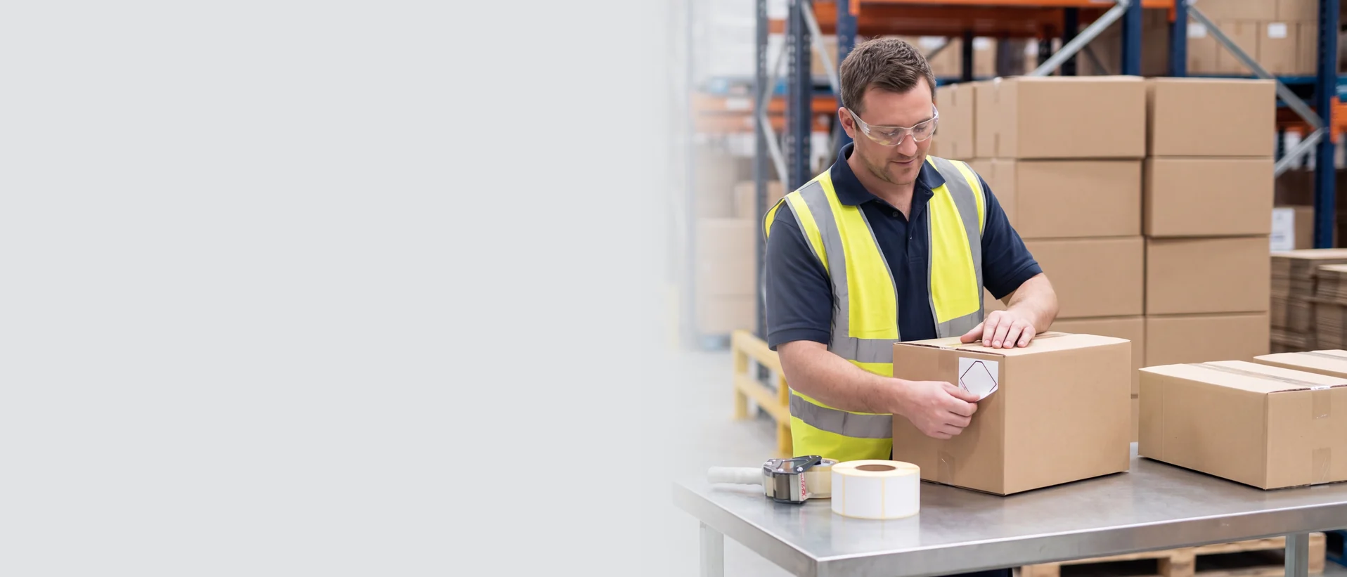 Hazmat employee labeling a package in a warehouse