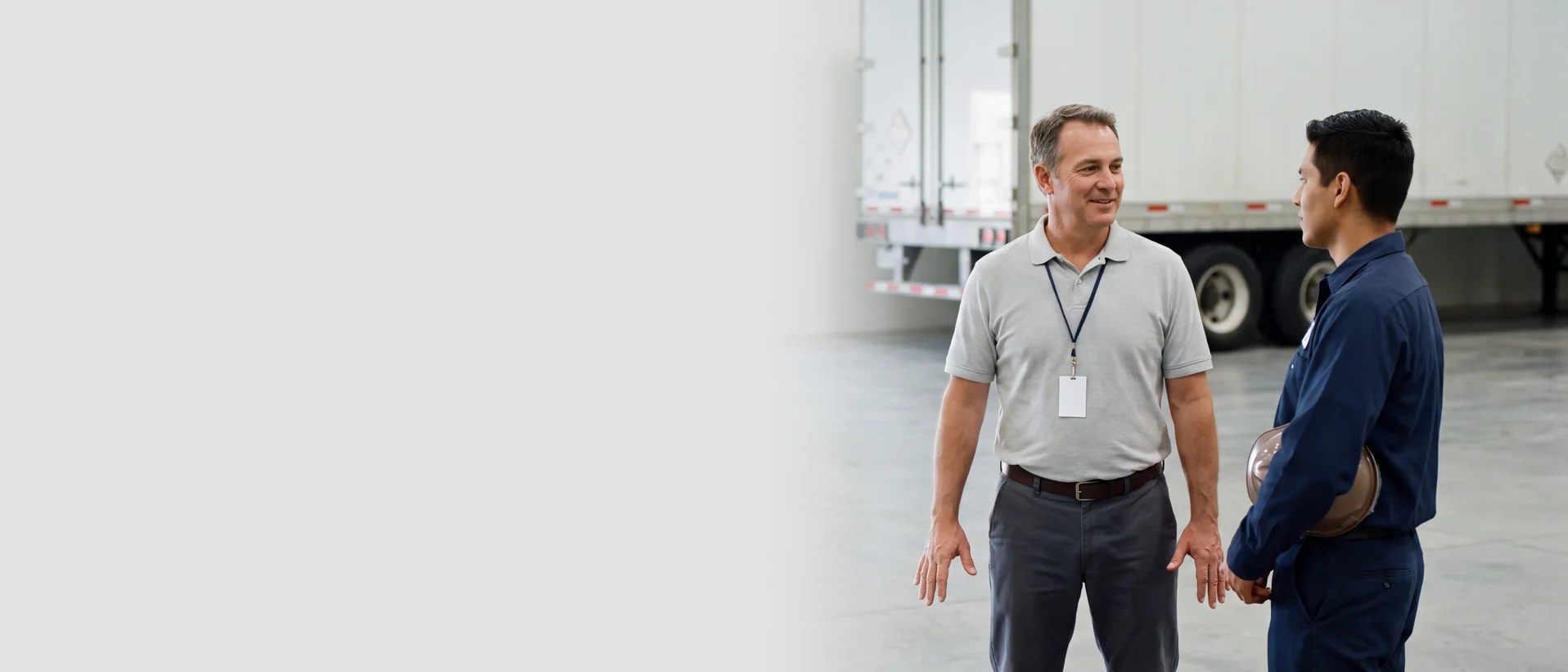 Supervisor speaking with a commercial driver in a fleet facility